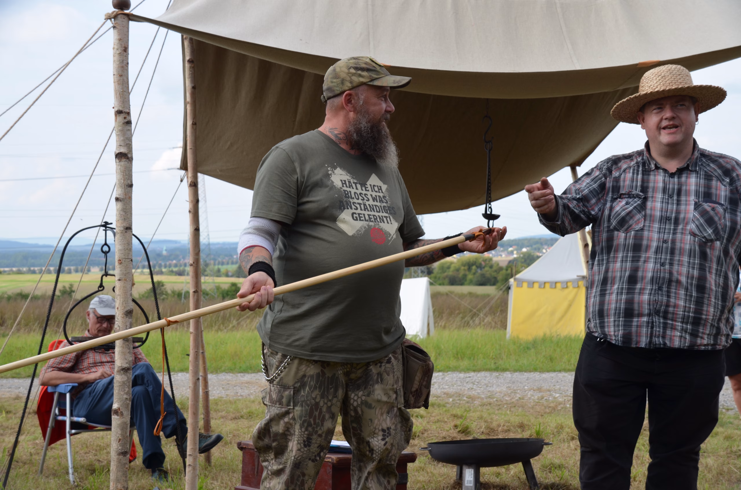 Zwei Bogenschützen im Gespräch unter einem Zelt beim Siebenberge Clout Bogenwettbewerb 2021 von Pfeilflugkunst.